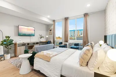 a bedroom with a large bed and a large window at 5 mins to Fillmore! Queen Bed, Rooftop, NorthernLibs! in Philadelphia