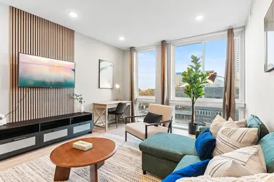 a living room with a couch and a table at 5 mins to FishTown plus Old Town King Bed, Sleeps 4! in Philadelphia
