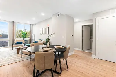 a living room with a table and chairs at 5 mins to FishTown plus Old Town King Bed, Sleeps 4! in Philadelphia