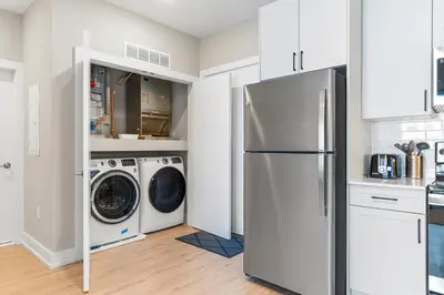a kitchen with a refrigerator and a washer and dryer at 5 mins to Convention Center! Sleeps 4! With Rooftop! in Philadelphia