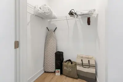 a room with a closet with a tie and a bag at 5 mins to Convention Center! Sleeps 4! With Rooftop! in Philadelphia