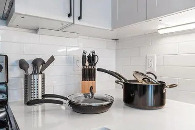 a kitchen counter with a pot and a pan and utensils at 5 mins to Convention Center! Sleeps 4! With Rooftop! in Philadelphia