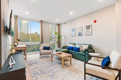 a living room with a green couch and chairs at 5 mins to Convention Center! Sleeps 4! With Rooftop! in Philadelphia
