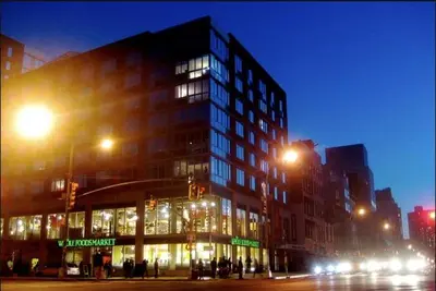 a large building on a city street at night at Stunning NYC Views! Free Gym! Doorman! Terrace! in New York