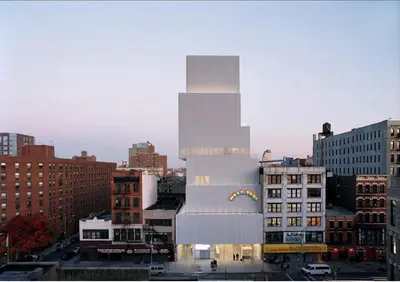 a tall white building in a city with buildings at Stunning NYC Views! Free Gym! Doorman! Terrace! in New York