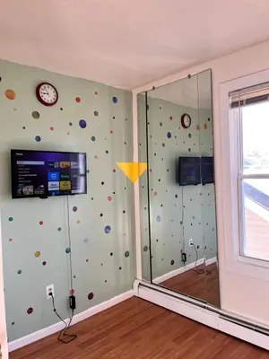 a room with a shower with a wall covered in balls at Amazing House near EWR and NYC in Linden