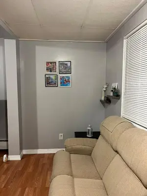 a living room with a couch and a window at Amazing House near EWR and NYC in Linden