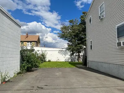 a white fence next to a white building at Amazing House near EWR and NYC in Linden