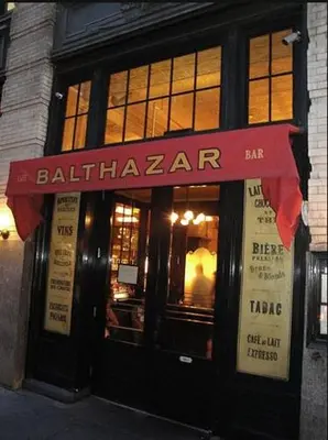 a restaurant with a red awning in front of a building at Doorman! High Floor! Views! Elevator! Free Gym! in New York