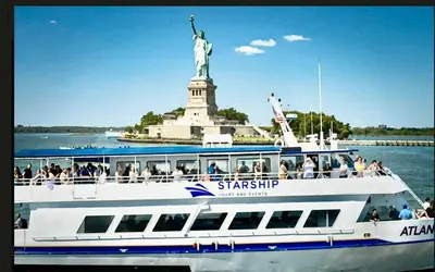 a boat in front of the statue of liberty at Apart Studio 12mint From New York City Times Square in West New York