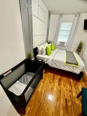 a small bedroom with a bed and a window at Apart Studio 12mint From New York City Times Square in West New York