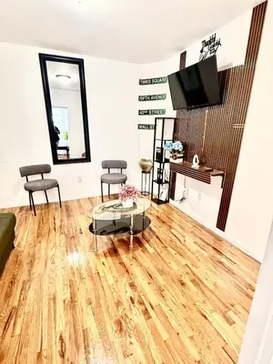 a living room with a wooden floor and a tv at Apart Studio 12mint From New York City Times Square in West New York