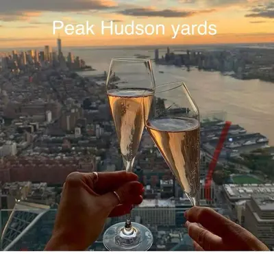 two people holding glasses of champagne in front of a city at Apart Studio 12mint From New York City Times Square in West New York