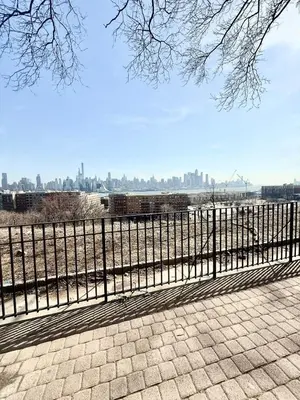 a black fence with a view of the city at Apart Studio 12mint From New York City Times Square in West New York
