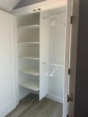 a walk in closet with white shelves at Walk to WP Gate and Free Parking in Highland Falls