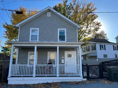 a person standing on the porch of a house at Walk to WP Gate and Free Parking in Highland Falls