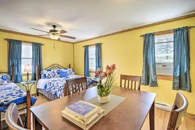 a living room with a table and a bed at 2BR Premium Duplex Close to Ski Slopes in Pleasant Mount