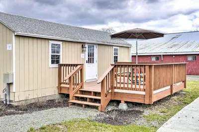a house with a large deck with an umbrella at Farm Stay Close to Ski Adventures in Pleasant Mount
