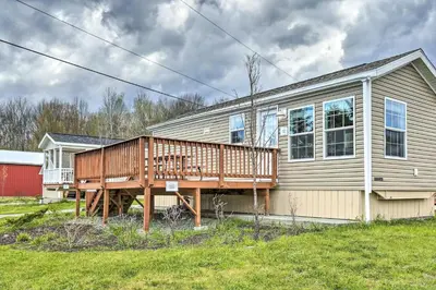 a house with a deck on the side of it at Vacation Cottage Getaway Close to Ski Resorts in Pleasant Mount