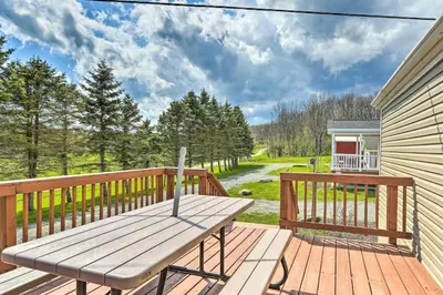 a wooden deck with a bench on top of it at Vacation Cottage Getaway Close to Ski Resorts in Pleasant Mount