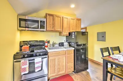a kitchen with a stainless steel stove and refrigerator at Suite to Unwind Close to Ski Slopes in Pleasant Mount
