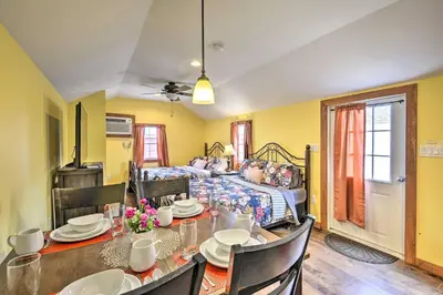 a dining room with a table and a bed at Suite to Unwind Close to Ski Slopes in Pleasant Mount