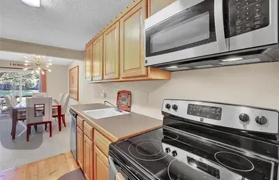 a kitchen with a stove and a sink and a microwave at Waterfront Mountain Fun-Jack Frost Walk On Whole House in Blakeslee