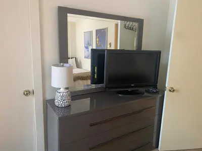 a television on a dresser with a lamp and a mirror at Waterfront Mountain Fun-Jack Frost Walk On Whole House in Blakeslee