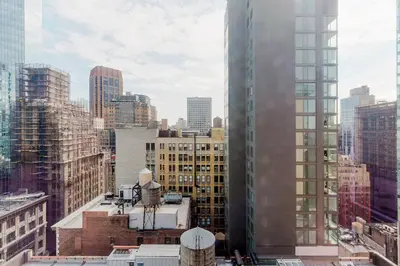 a view of a city skyline with tall buildings at Blueground Midtown S gym AC nr Empire St NYC-1591 in New York
