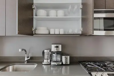 a kitchen with a sink and a counter top at Blueground Midtown S gym AC nr Empire St NYC-1591 in New York