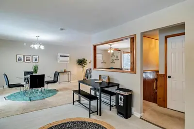 a dining room and living room with a table and chairs at Pool Access! All-Season Family Home in Poconos in Crescent Lake