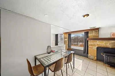 a dining room with a table and chairs and a fireplace at Comfort, Fun, & Charming - 5BR Oasis with Pool in Coatesville