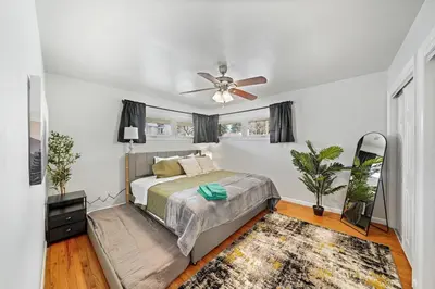 a bedroom with a bed and a ceiling fan at Comfort, Fun, & Charming - 5BR Oasis with Pool in Coatesville