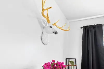 a white deer head with antlers hanging on a wall at Comfort, Fun, & Charming - 5BR Oasis with Pool in Coatesville
