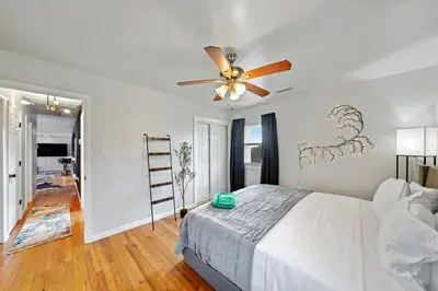 a bedroom with a bed and a ceiling fan at Comfort, Fun, & Charming - 5BR Oasis with Pool in Coatesville