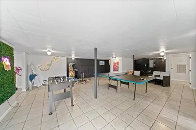 a living room with a ping pong table in it at Comfort, Fun, & Charming - 5BR Oasis with Pool in Coatesville