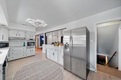 a large kitchen with a stainless steel refrigerator at Comfort, Fun, & Charming - 5BR Oasis with Pool in Coatesville