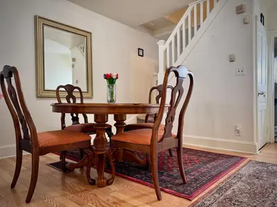 a dining room table with chairs and a mirror at Providence & 18th in Chester