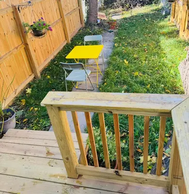 a wooden deck with a yellow table and chairs at Providence & 18th in Chester