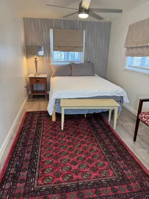 a bedroom with a bed with a red rug at Providence & 18th in Chester
