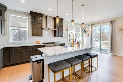 a kitchen with a large island with bar stools at 10 Mi to Morristown Stylish Home Near Trails! in Denville