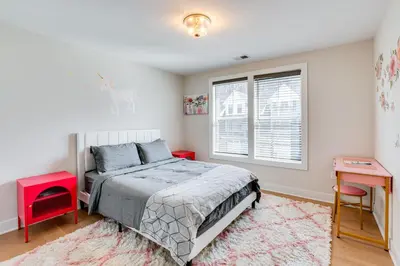 a bedroom with a bed and two tables and a window at 10 Mi to Morristown Stylish Home Near Trails! in Denville