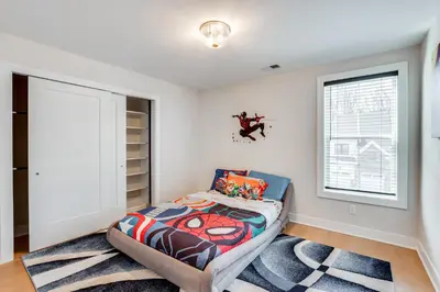 a bedroom with a bed and a window at 10 Mi to Morristown Stylish Home Near Trails! in Denville