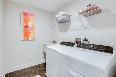 a white laundry room with a washer and dryer at 10 Mi to Morristown Stylish Home Near Trails! in Denville