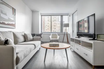 a living room with a couch and a tv at UWS 1BR w WD nr Lincoln Center NYC-1187 in New York