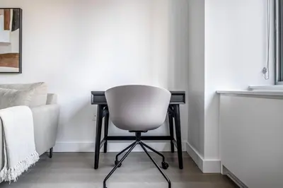 a white chair in a room with a desk at UWS 1BR w WD nr Lincoln Center NYC-1187 in New York