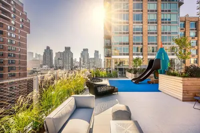 a rooftop patio with a slide on a building at UWS 1BR w WD nr Lincoln Center NYC-1187 in New York
