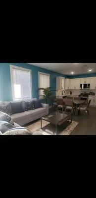 a living room with a couch and a table at Tasteful 3bedroom Vacation home in Newark