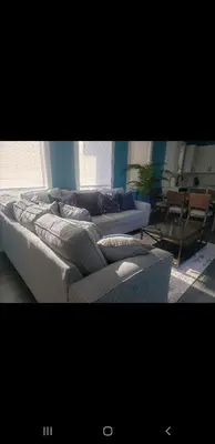 a living room with two couches and a table at Tasteful 3bedroom Vacation home in Newark