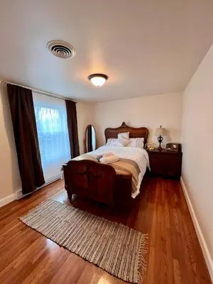 a bedroom with a bed and a window and a rug at Cozy House